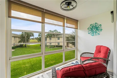 a view of a porch with furniture and garden