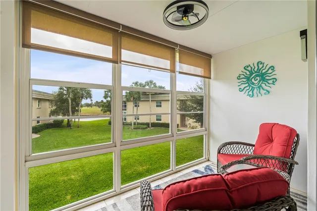a view of a porch with furniture and garden