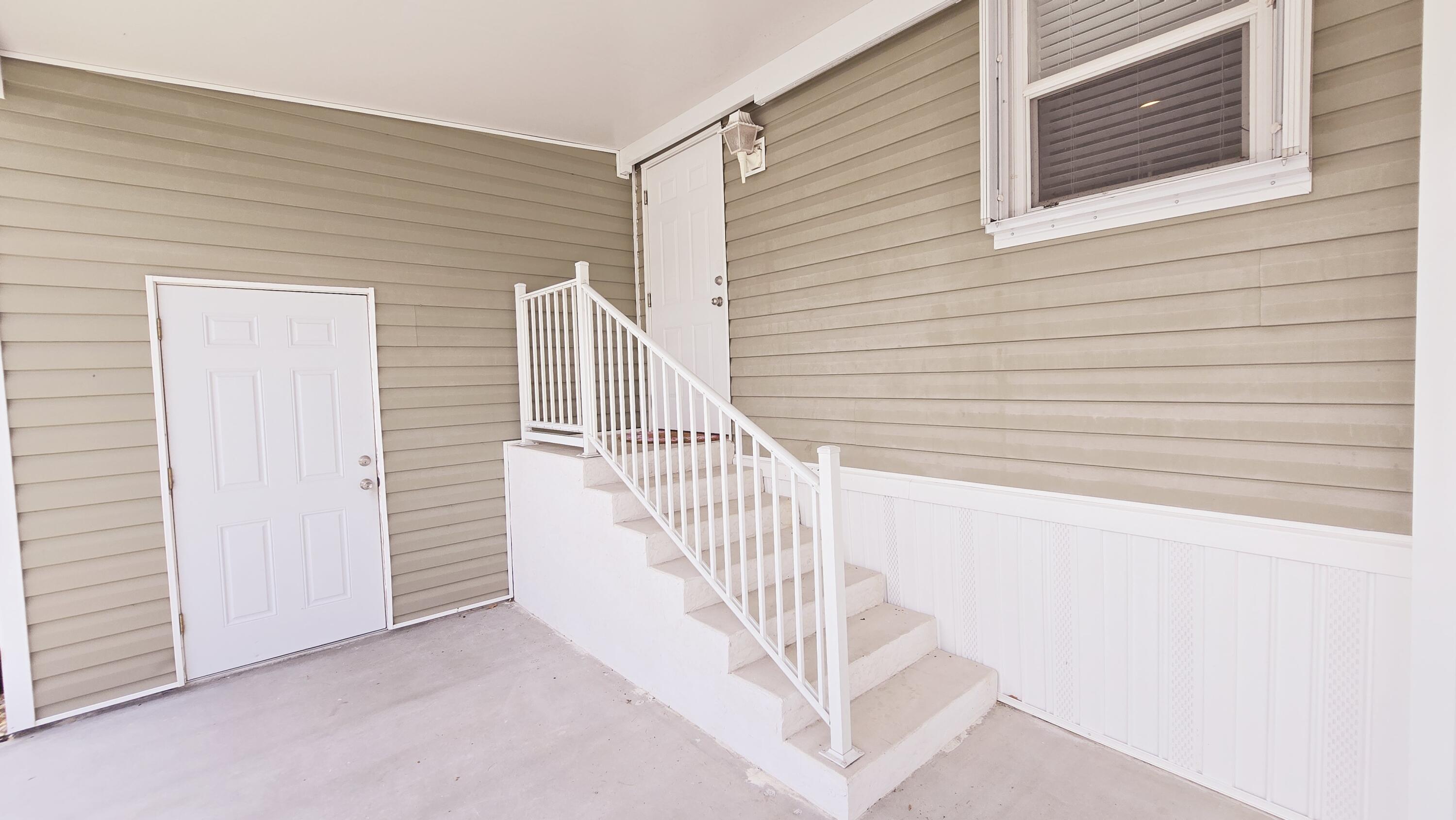 6939 Southeast Ridgeway Terrace Hobe Sound, FL 33455 - Photo 56 of 68 carport entrance & storage door