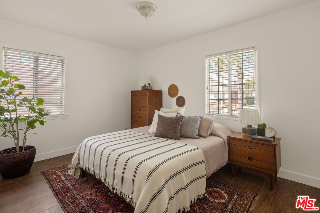 13610 Bracken Street Arleta, CA 91331 - Photo 14 of 23 a bedroom with a bed potted plant and a window