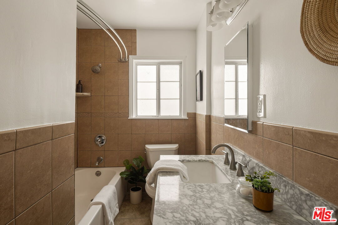 13610 Bracken Street Arleta, CA 91331 - Photo 16 of 23 a bathroom with a tub sink and mirror