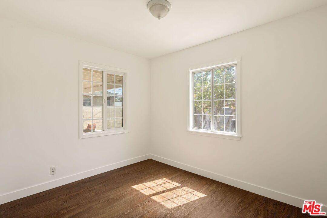 13610 Bracken Street Arleta, CA 91331 - Photo 17 of 23 an empty room with wooden floor and windows