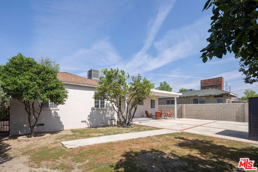 13610 Bracken Street Arleta, CA 91331 - Photo 21 of 23 a front view of a house with a yard and garage