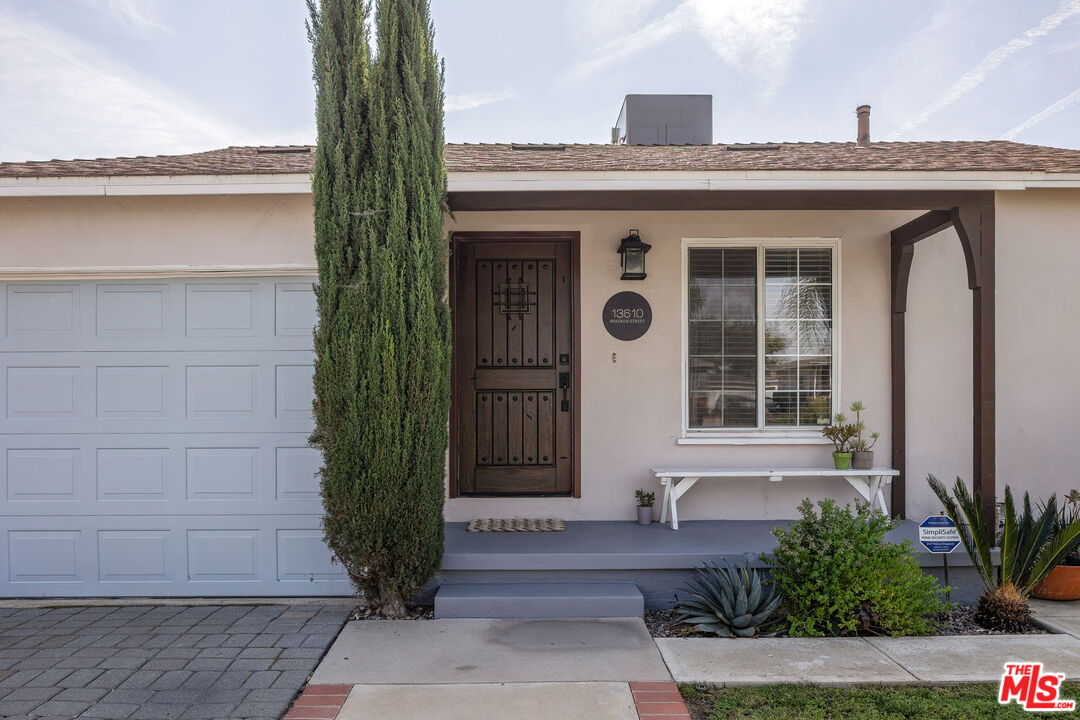 13610 Bracken Street Arleta, CA 91331 - Photo 4 of 23 a front view of a house with garden