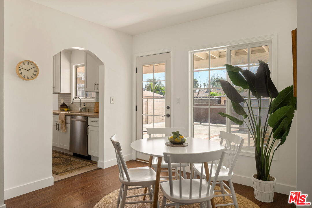13610 Bracken Street Arleta, CA 91331 - Photo 8 of 23 a view of a dining room with furniture and wooden floor