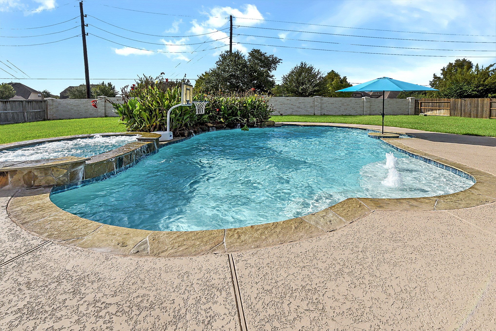 2951 Bobby Jones Road Katy, TX 77494 - Photo 5 of 50 Another view highlights this private backyard oasis, featuring a beautiful waterfall. The pool includes a shallow step, sun deck, perfect for lounging, relaxing, and staying cool during the hot summer months.