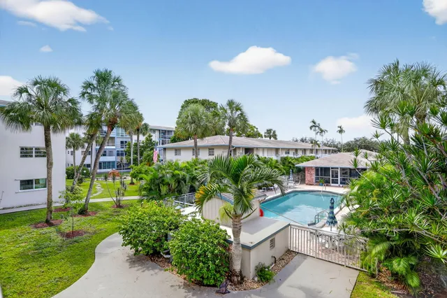a view of a patio with table and chairs and potted plants