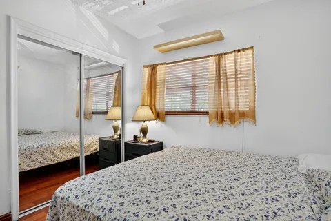 a bedroom with bed and window