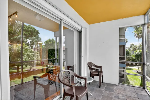 a balcony with table and chairs