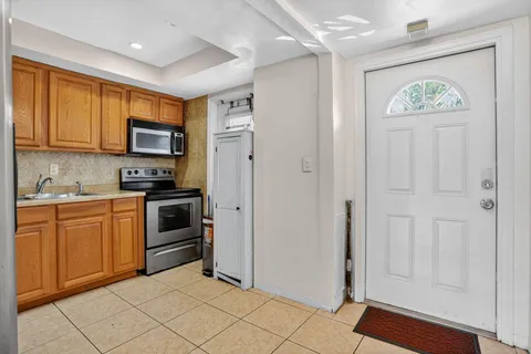 a kitchen with stainless steel appliances granite countertop a refrigerator and a stove top oven
