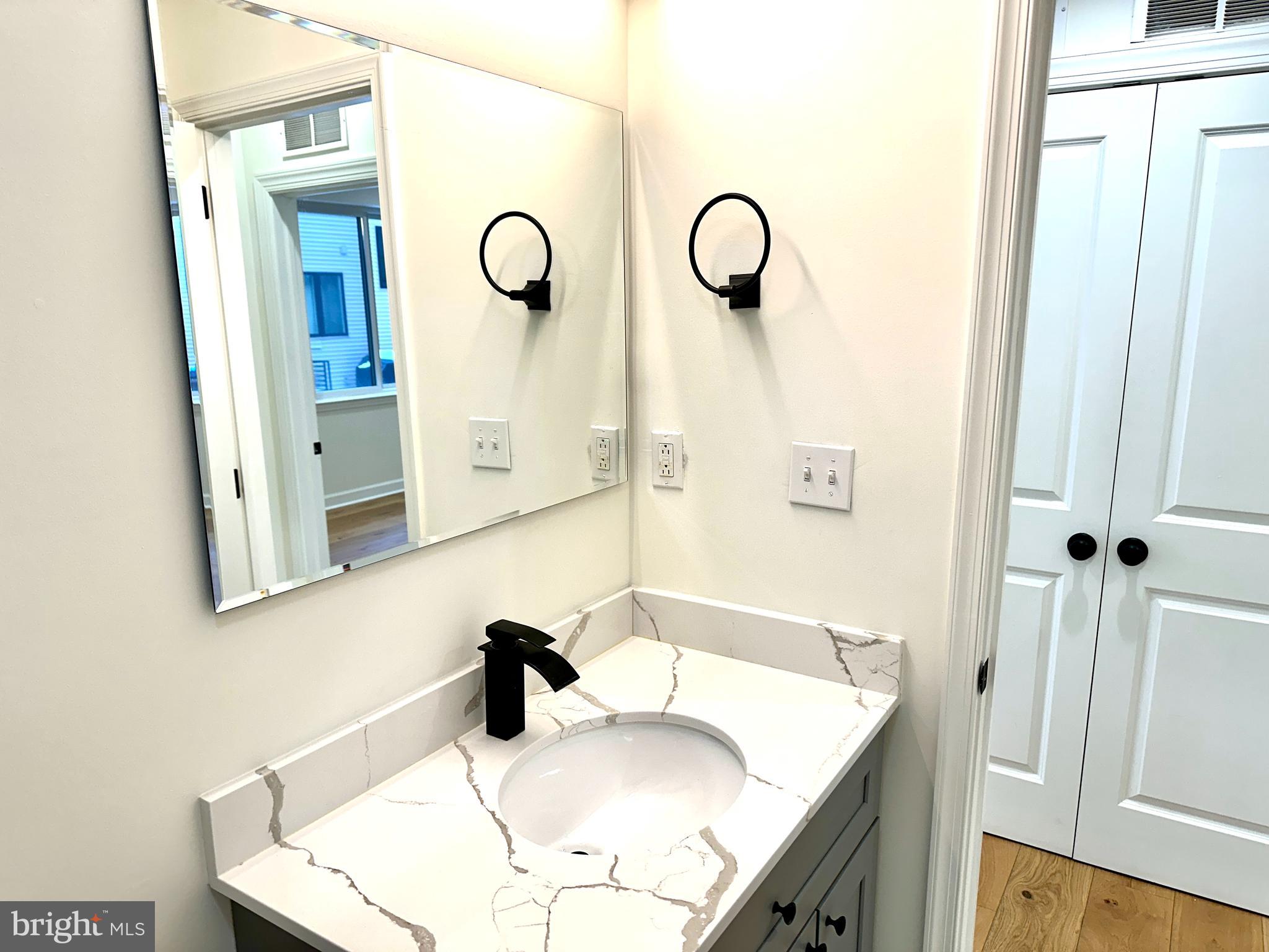 2009 North Reese Street, Unit 8B Philadelphia, PA 19122 - Photo 12 of 12 a bathroom with a sink vanity and a mirror