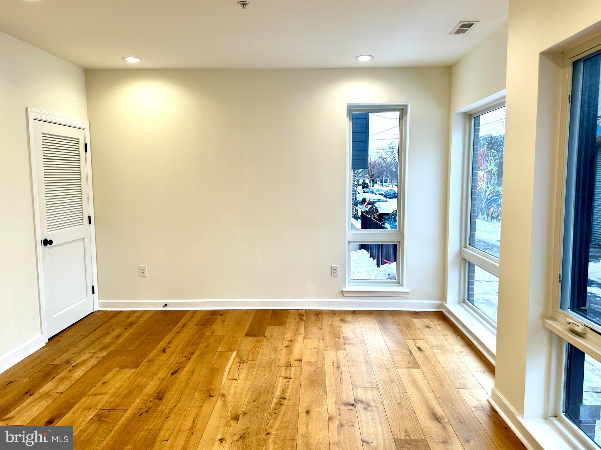 2009 North Reese Street, Unit 8B Philadelphia, PA 19122 - Photo 2 of 12 a view of a room with wooden floor and windows