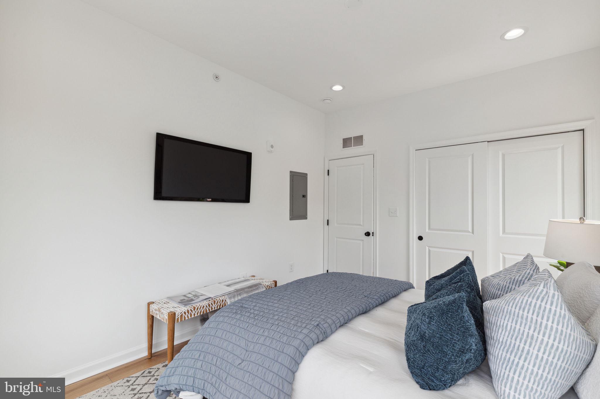 2009 North Reese Street, Unit 8B Philadelphia, PA 19122 - Photo 6 of 12 a bedroom with a bed and a flat screen tv