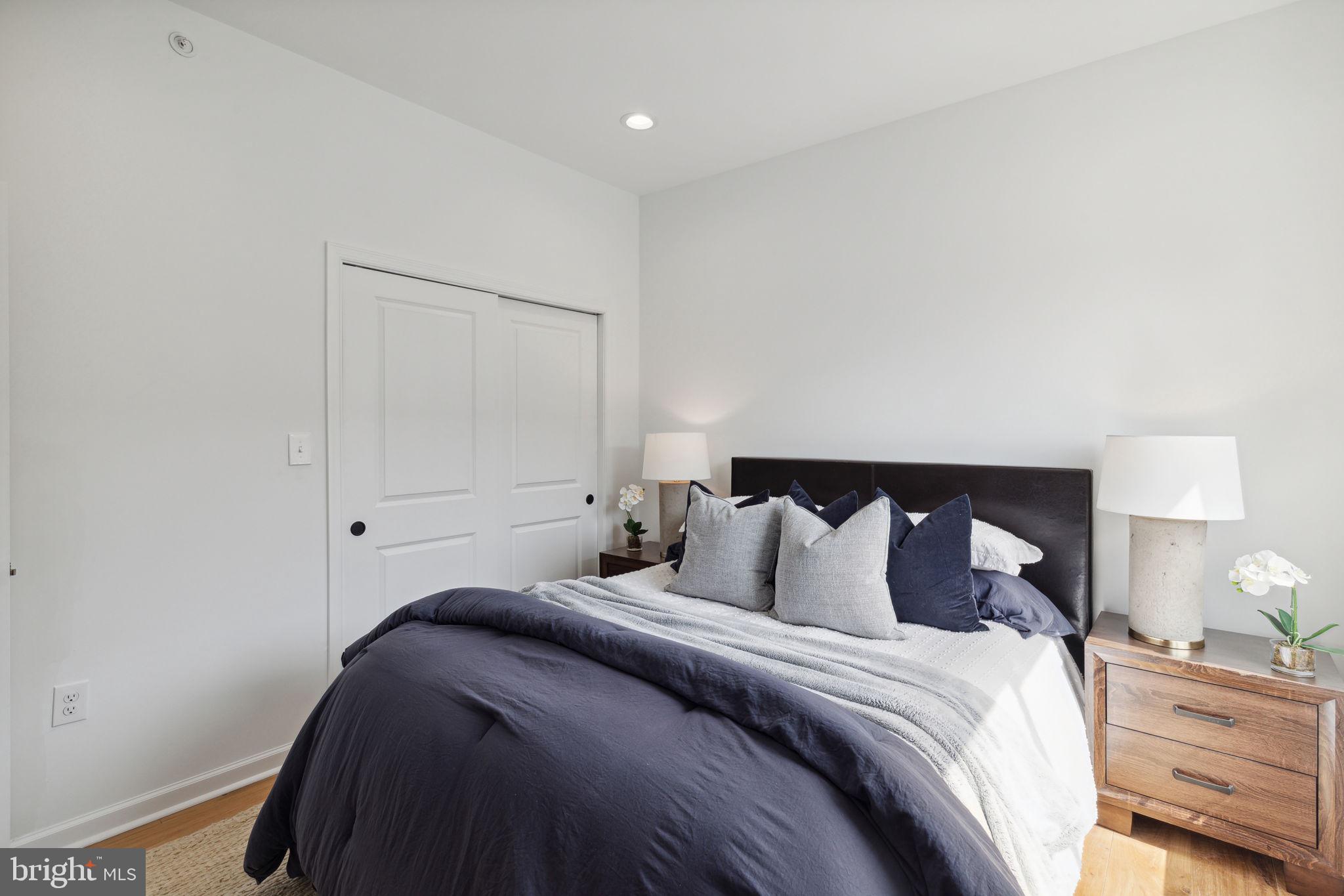 2009 North Reese Street, Unit 8B Philadelphia, PA 19122 - Photo 8 of 12 a bedroom with a bed and a lamp