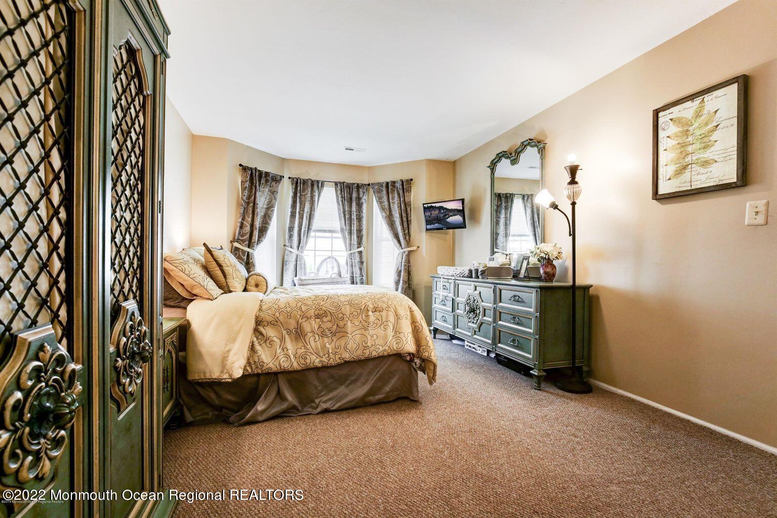 123 Hyacinth Lane Freehold, NJ 07728 - Photo 15 of 28 a bed sitting in a bedroom next to a window