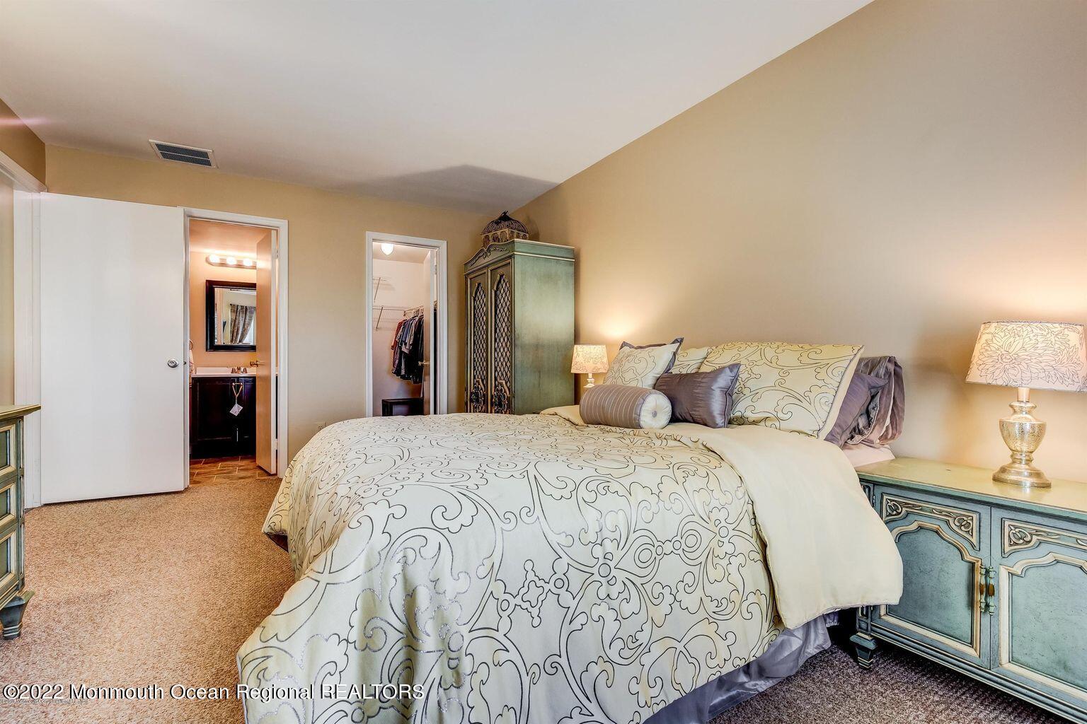 123 Hyacinth Lane Freehold, NJ 07728 - Photo 16 of 28 a spacious bedroom with a bed and a lamp