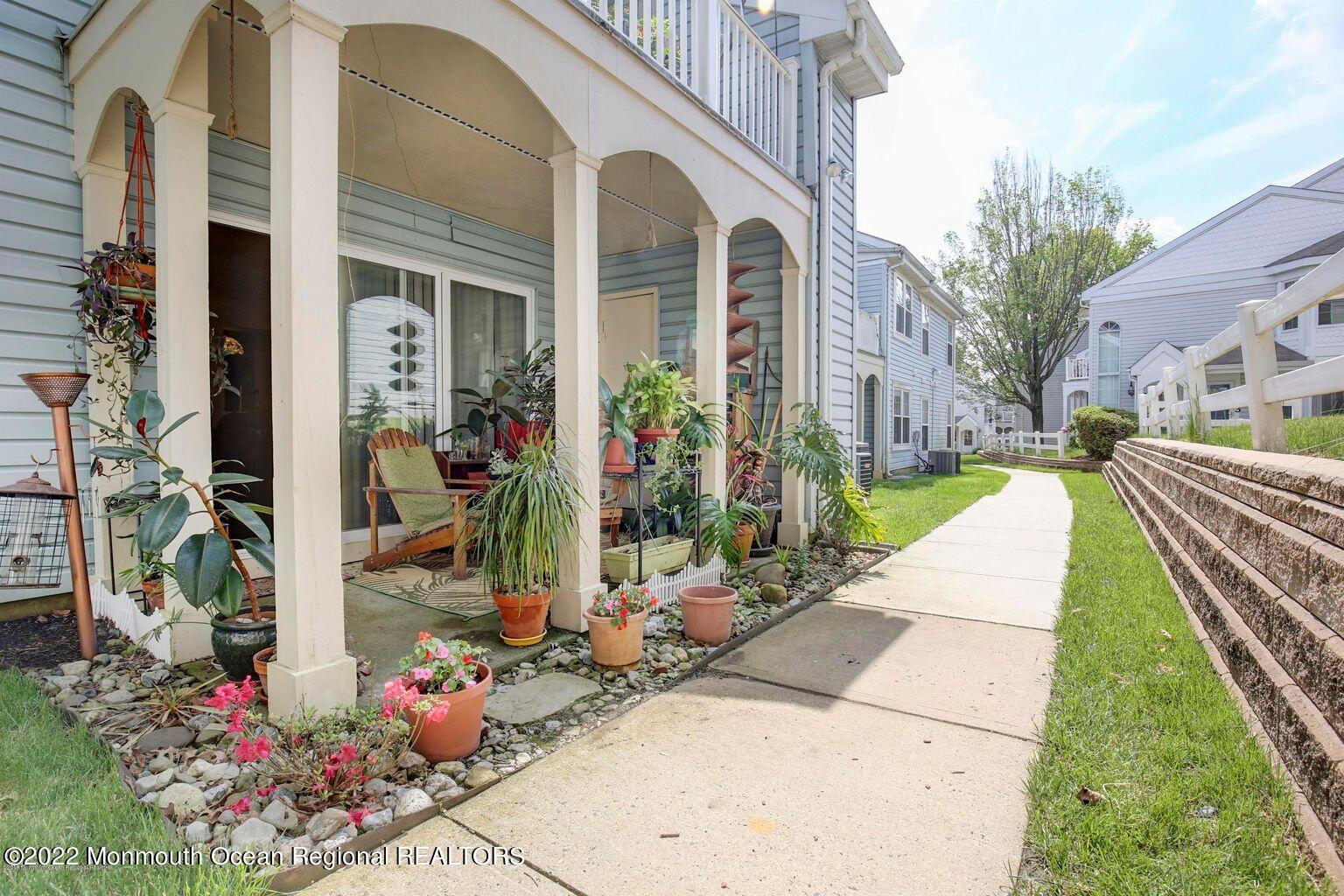 123 Hyacinth Lane Freehold, NJ 07728 - Photo 24 of 28 a view of a potted flower in front of a house