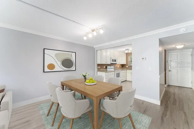 a view of a dining room with furniture and wooden floor