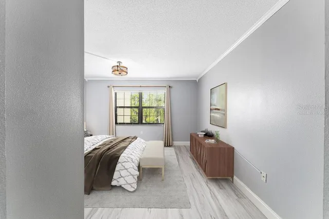 a bedroom with bed and window