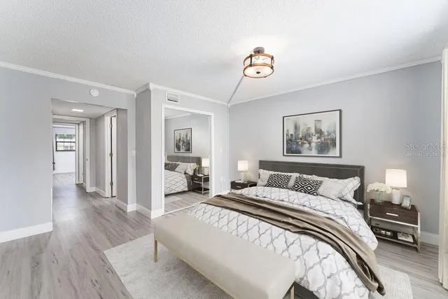 a bedroom with a bed and a chandelier