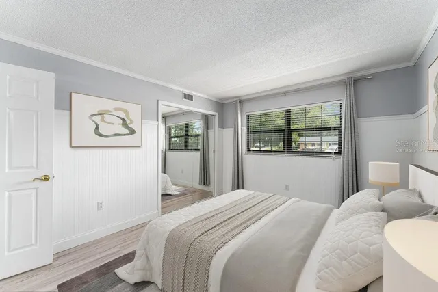 a bedroom with a large bed and a window