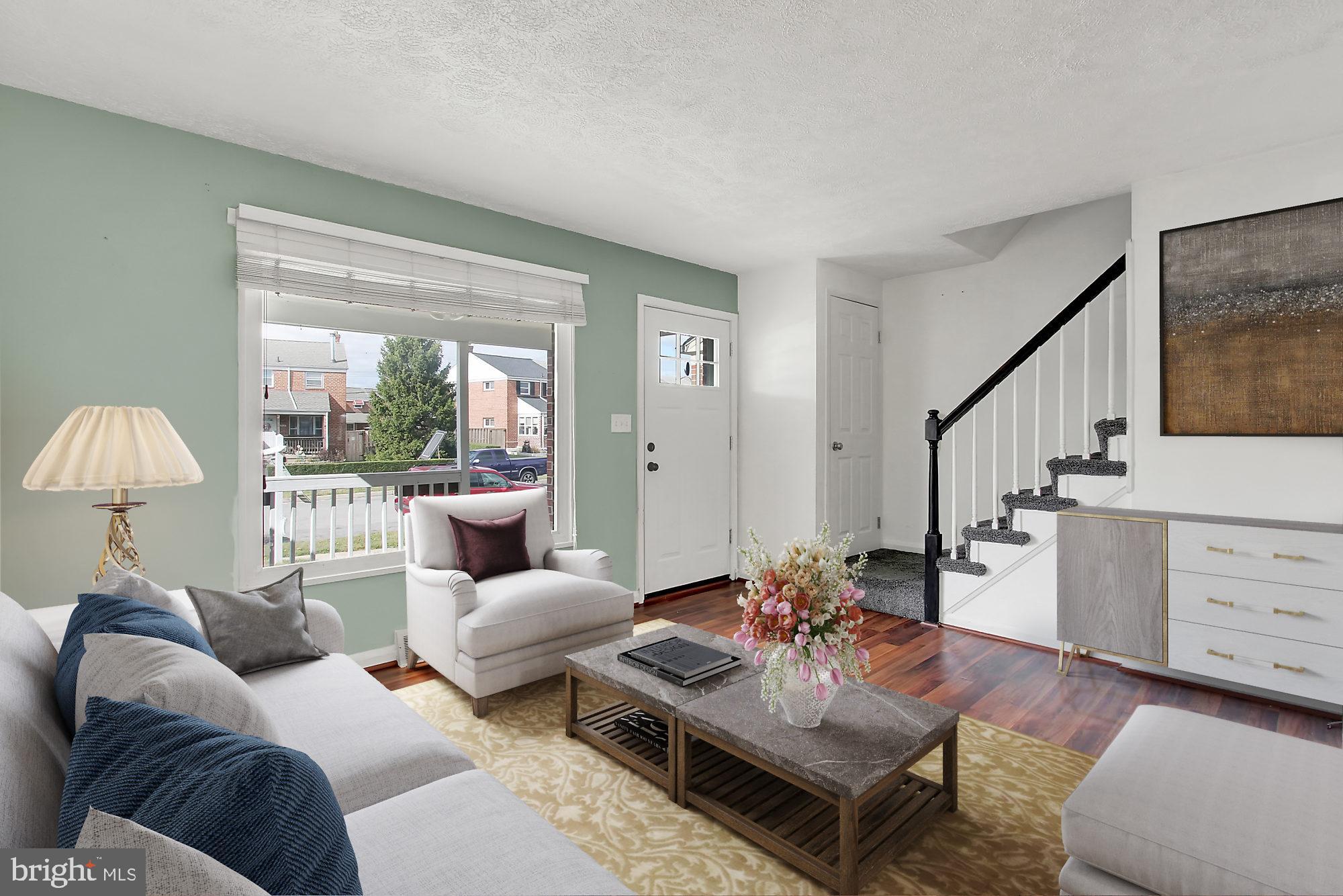 7817 Lockwood Road Baltimore, MD 21222 - Photo 2 of 23 a living room with furniture a lamp wooden floor and a large window