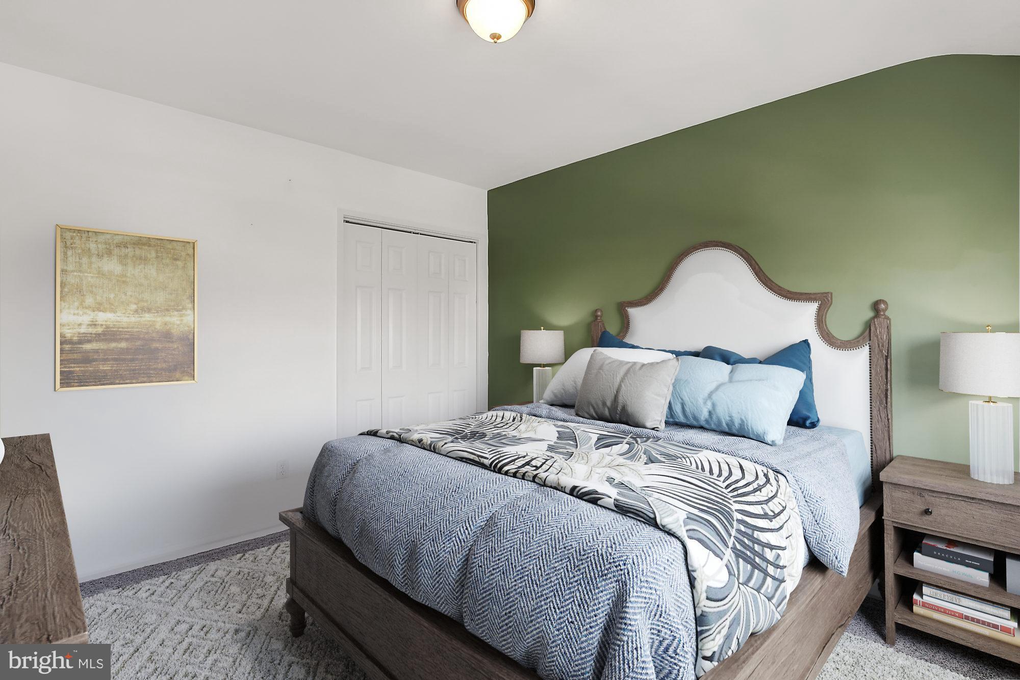 7817 Lockwood Road Baltimore, MD 21222 - Photo 11 of 23 a bedroom with a bed and a potted plant