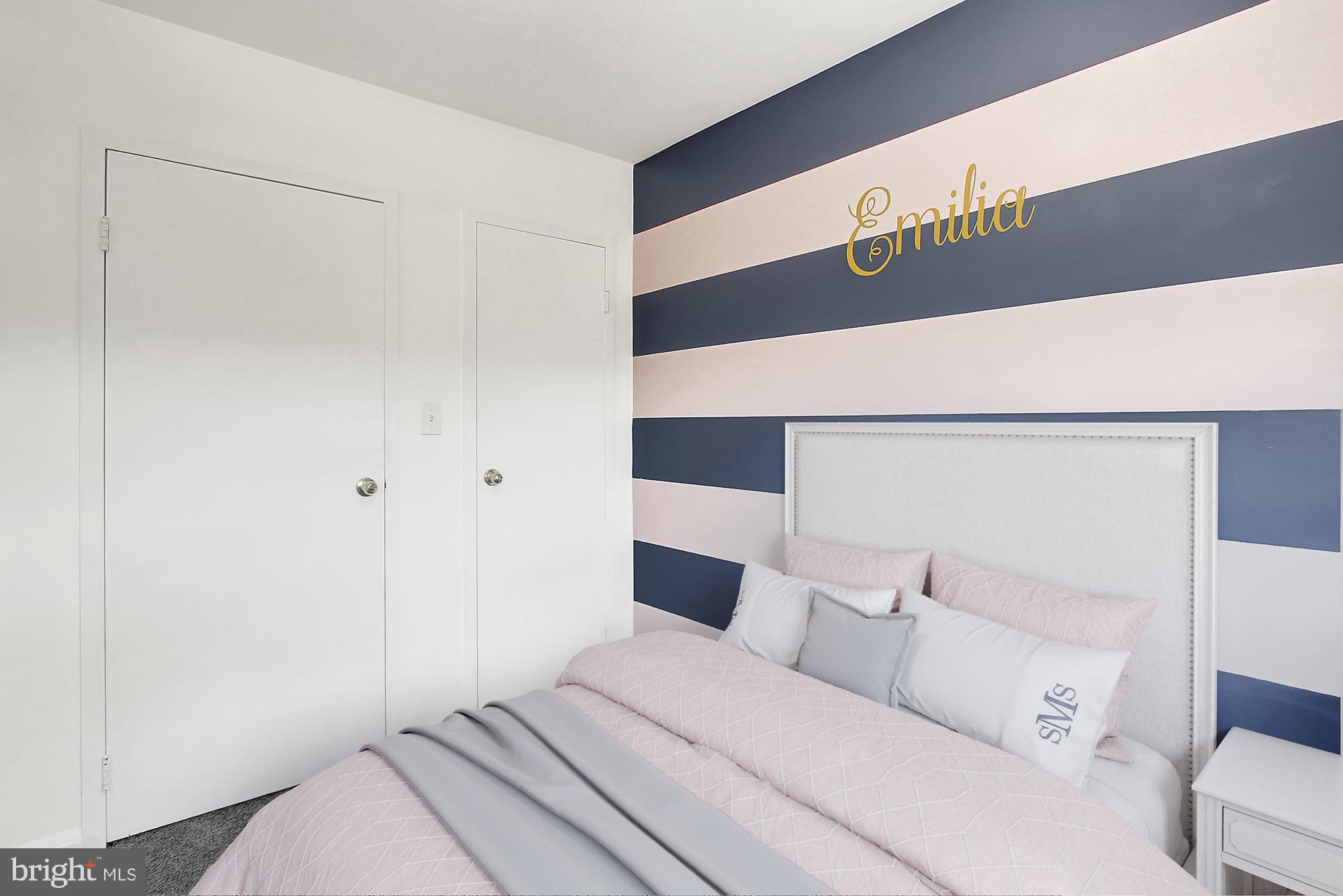 7817 Lockwood Road Baltimore, MD 21222 - Photo 16 of 23 a bedroom with a bed and a walk in closet