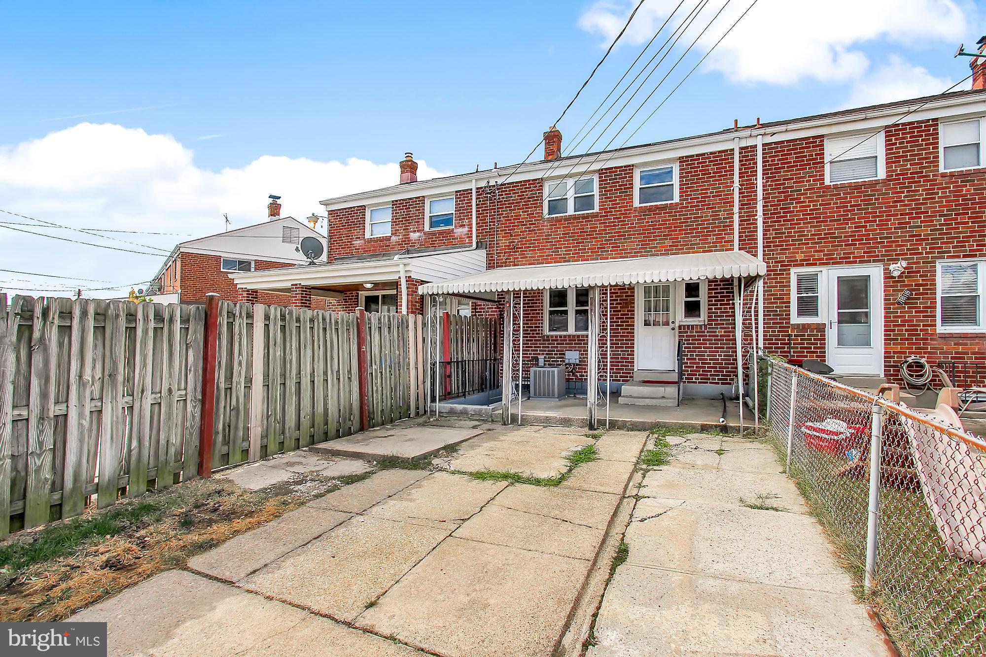 7817 Lockwood Road Baltimore, MD 21222 - Photo 21 of 23 a view of a brick building with a small yard