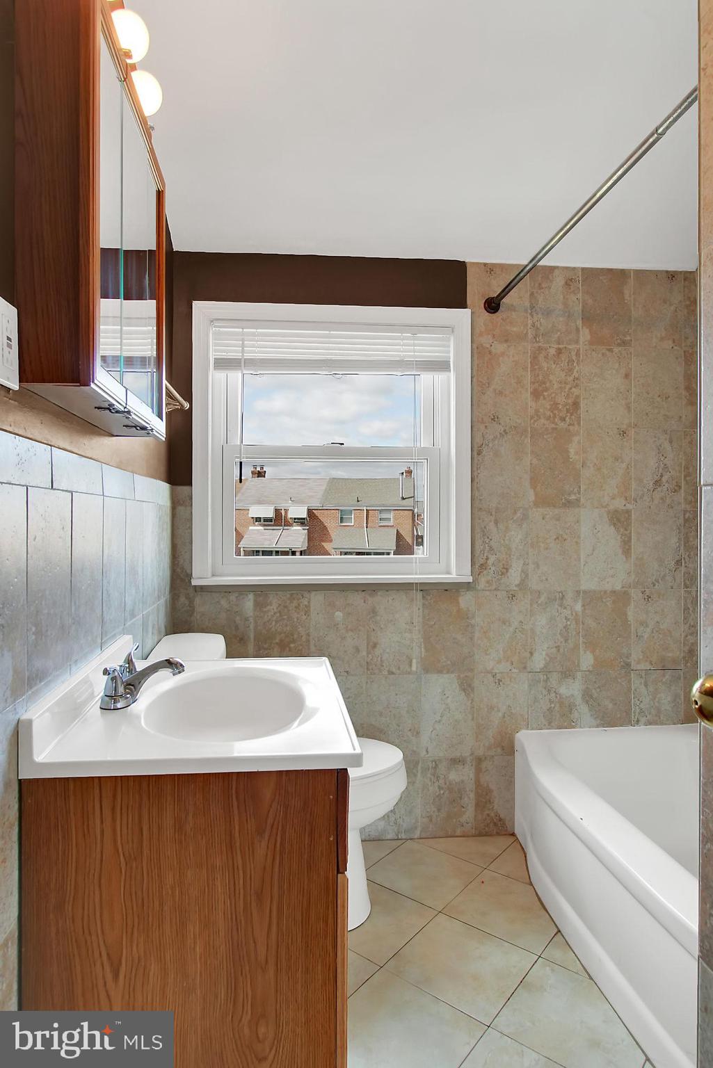 7817 Lockwood Road Baltimore, MD 21222 - Photo 10 of 23 a bathroom with a sink and a bathtub