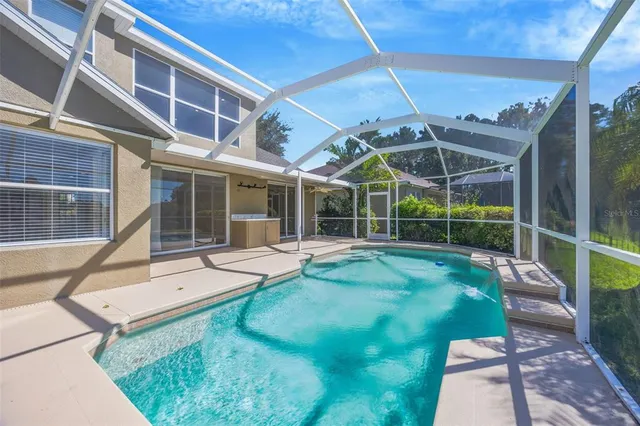 a view of a house with backyard and sitting area