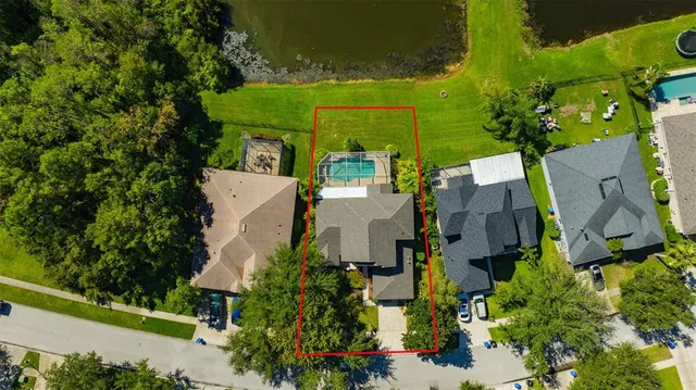 an aerial view of a house with a garden and trees