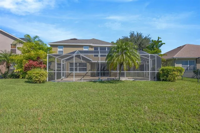 a view of a house with a yard and sitting area