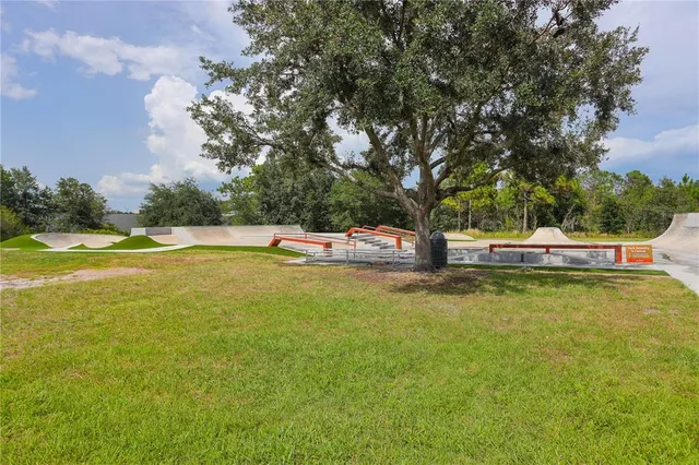 a view of a swimming pool with an outdoor seating and yard