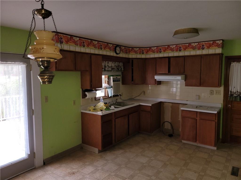 3143 Georgetown Road Polk, PA 16342 - Photo 3 of 15 a kitchen with granite countertop a sink and a refrigerator