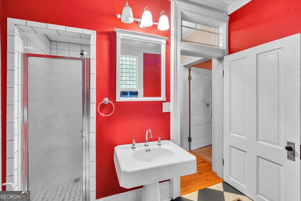 212 East Union Street Vienna, GA 31092 - Photo 29 of 62 a bathroom with a sink a mirror and a shower