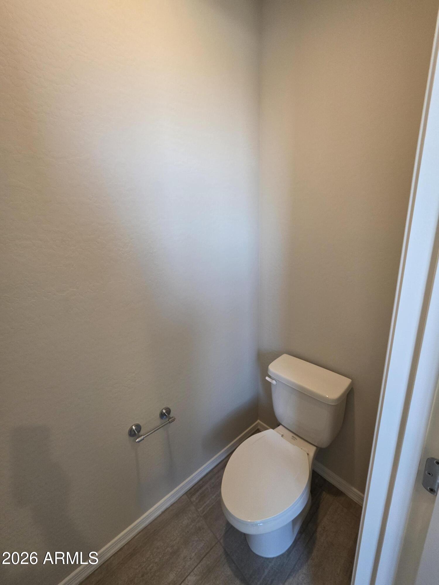 7128 West Coles Road Laveen, AZ 85339 - Photo 20 of 38 a white toilet sitting next to a white cabinet