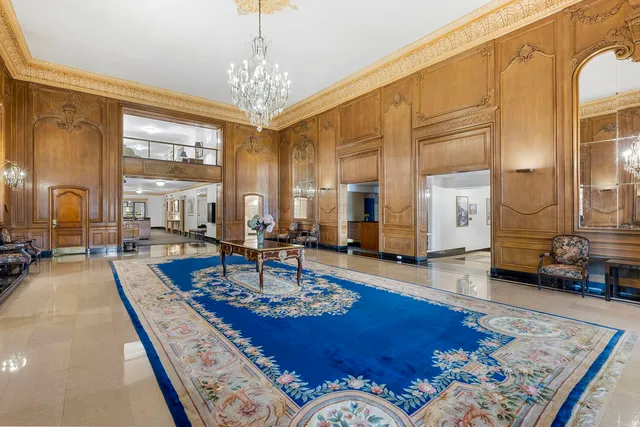 a living room with fireplace furniture and a table