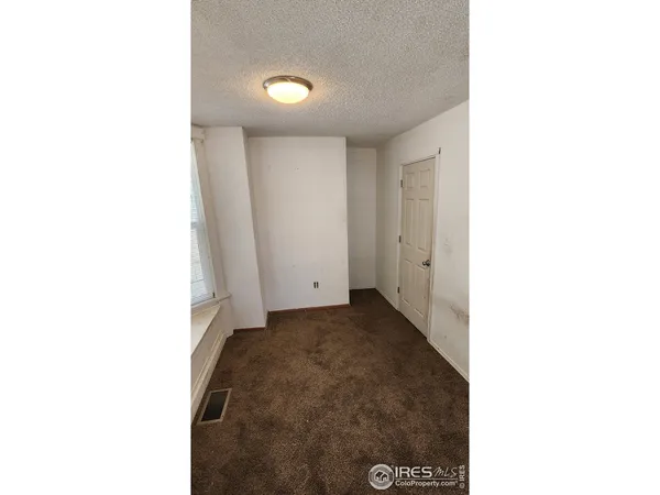 a view of a room that has a grey cabinets