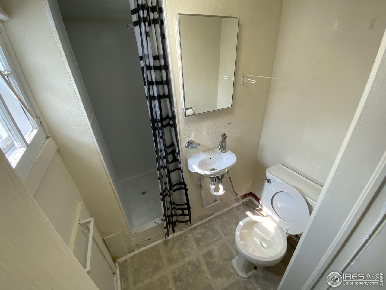 303 South 2nd Street Sterling, CO 80751 - Photo 37 of 37 a bathroom with a sink a toilet and a mirror