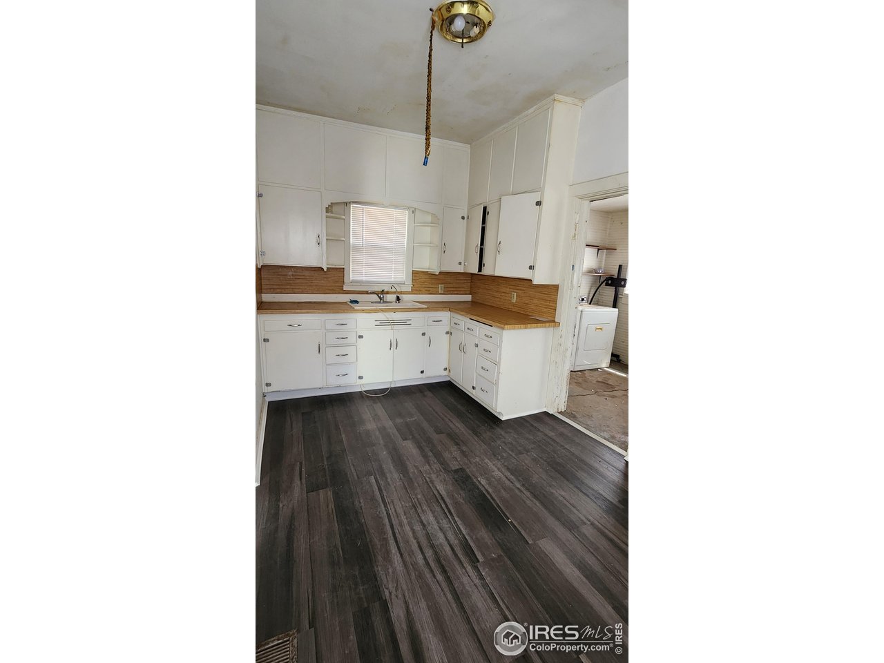 303 South 2nd Street Sterling, CO 80751 - Photo 8 of 37 a kitchen with a sink and cabinets