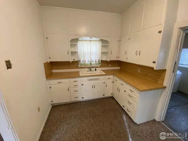 a utility room with cabinets washer and dryer