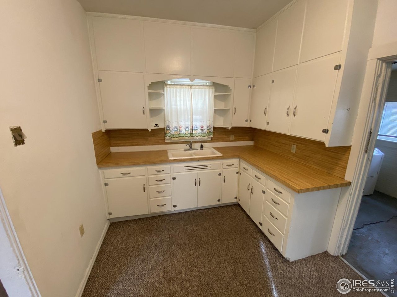 303 South 2nd Street Sterling, CO 80751 - Photo 9 of 37 a utility room with cabinets washer and dryer