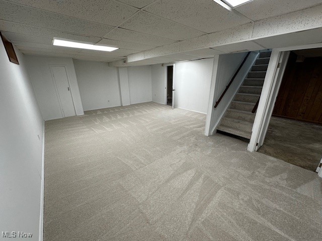 586 Ingalls Road Akron, OH 44312 - Photo 18 of 21 Finished basement with a drop ceiling, carpet floors, and stairs