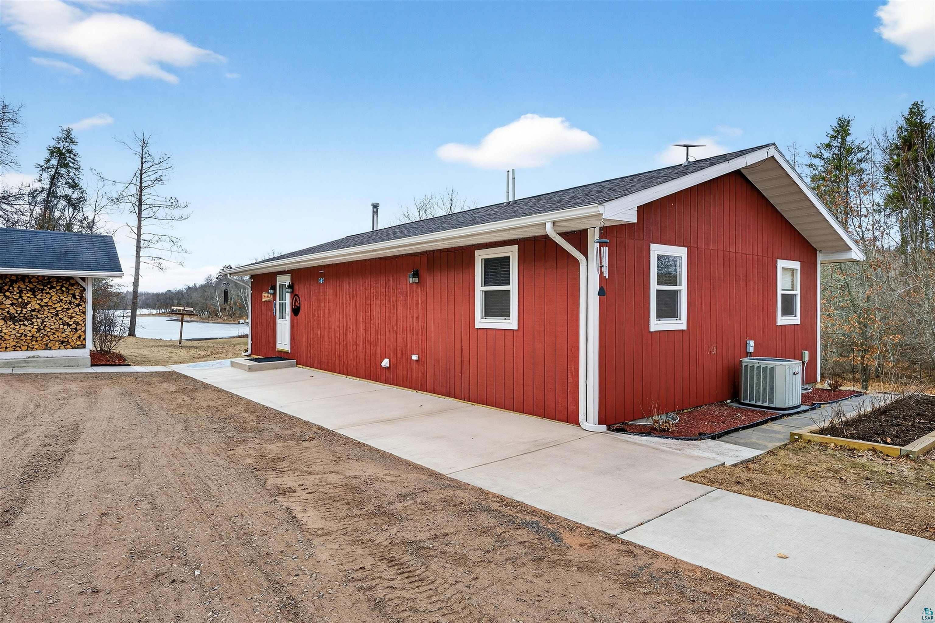 11702 East Mail Road Gordon, WI 54838 - Photo 9 of 49 View of side of home featuring a shingled roof and a cooling unit