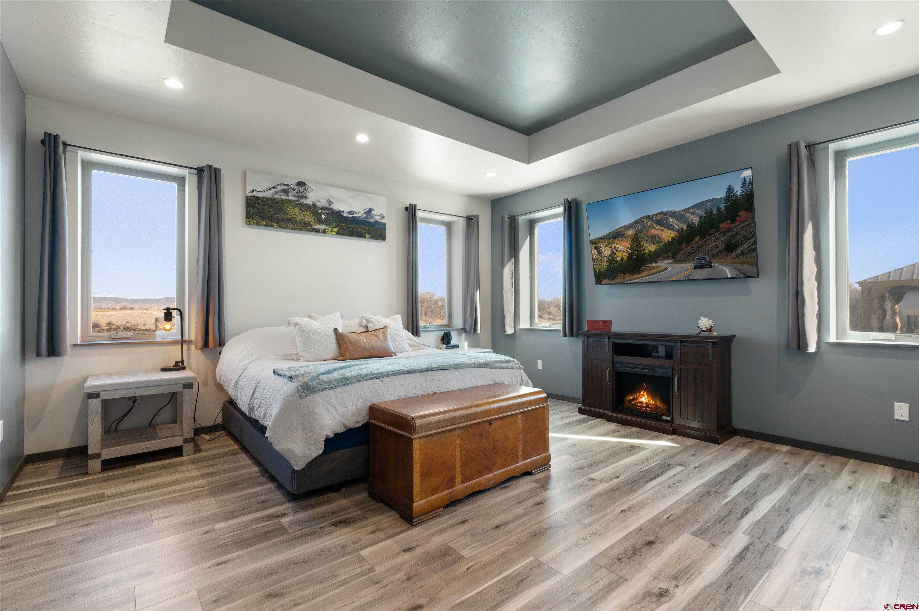 55347 Begonia Road Delta, CO 81416 - Photo 9 of 44 a spacious bedroom with a bed and a fireplace