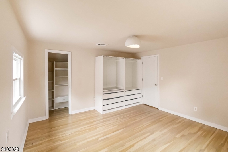31 Sherman Avenue Hawthorne, NJ 07506 - Photo 11 of 23 an empty room with wooden floor and windows