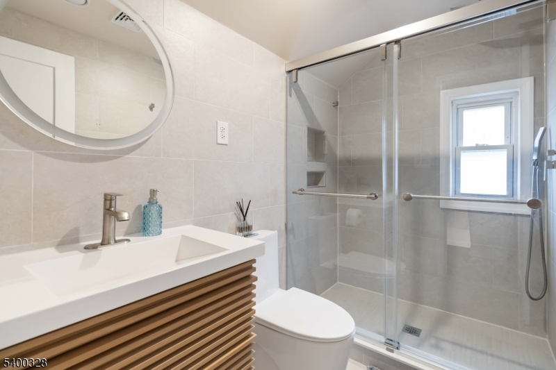 31 Sherman Avenue Hawthorne, NJ 07506 - Photo 12 of 23 a bathroom with a sink a toilet and shower