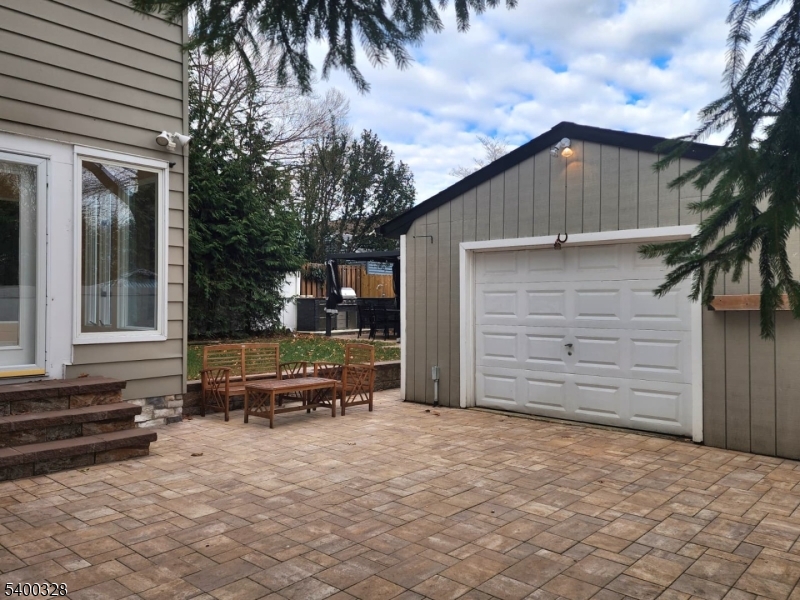 31 Sherman Avenue Hawthorne, NJ 07506 - Photo 16 of 23 a backyard of a house with barbeque oven and outdoor seating