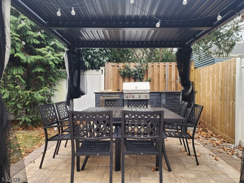 31 Sherman Avenue Hawthorne, NJ 07506 - Photo 19 of 23 a view of an outdoor dining space with a table and chairs